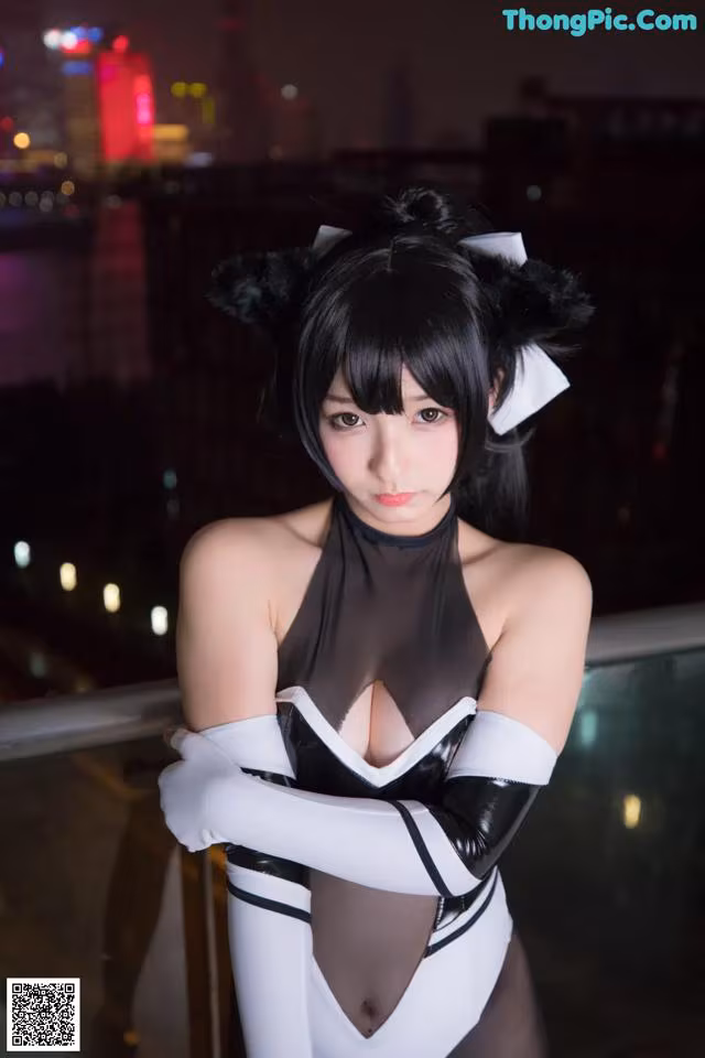 A woman in a black and white outfit posing for a picture.