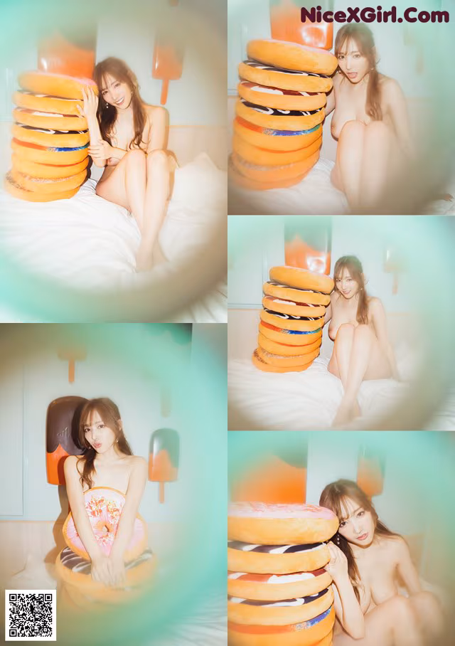 A woman sitting on top of a bed next to a pile of donuts.