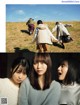 A group of young women standing on top of a grass covered field.