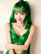 A woman with green hair wearing a green dress.