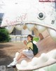 A woman sitting on top of a giant shark statue.